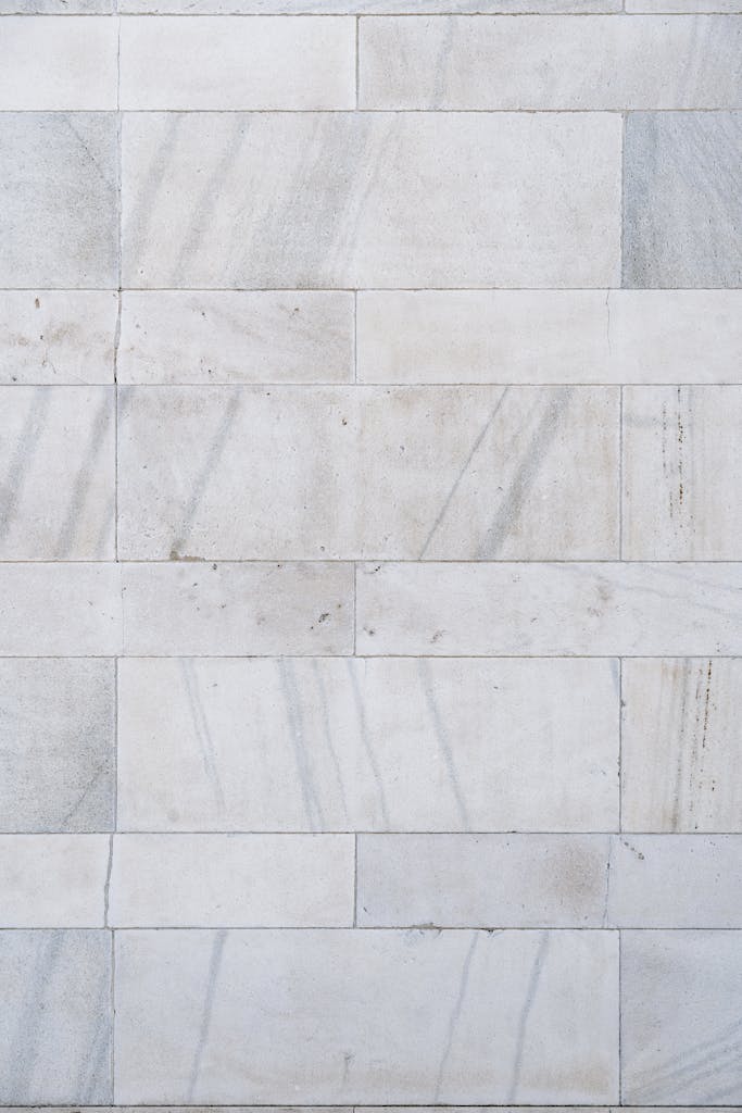 Full frame background of part of concrete wall with marble tiles with gray mottlings
