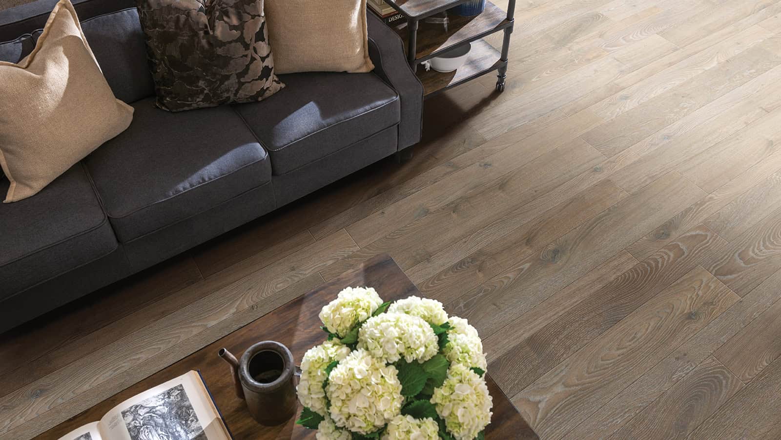 Couch and table on laminate floor.